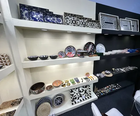 Shelves of bone inlay trays, horn and shell pieces on the Chowringhee Arts stand at IHGF Delhi Fair